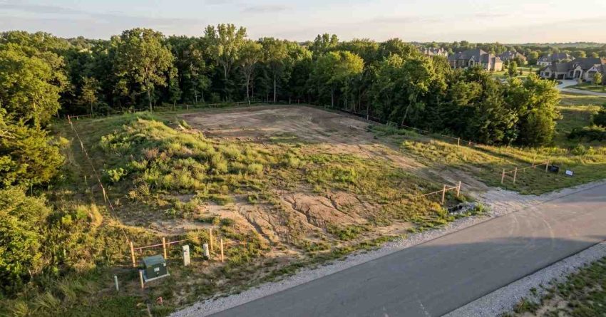 Vacant land parcel with graded homesite and survey boundary stakes
